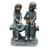 Girl and Boy Sitting on Bench with Puppy Statue
